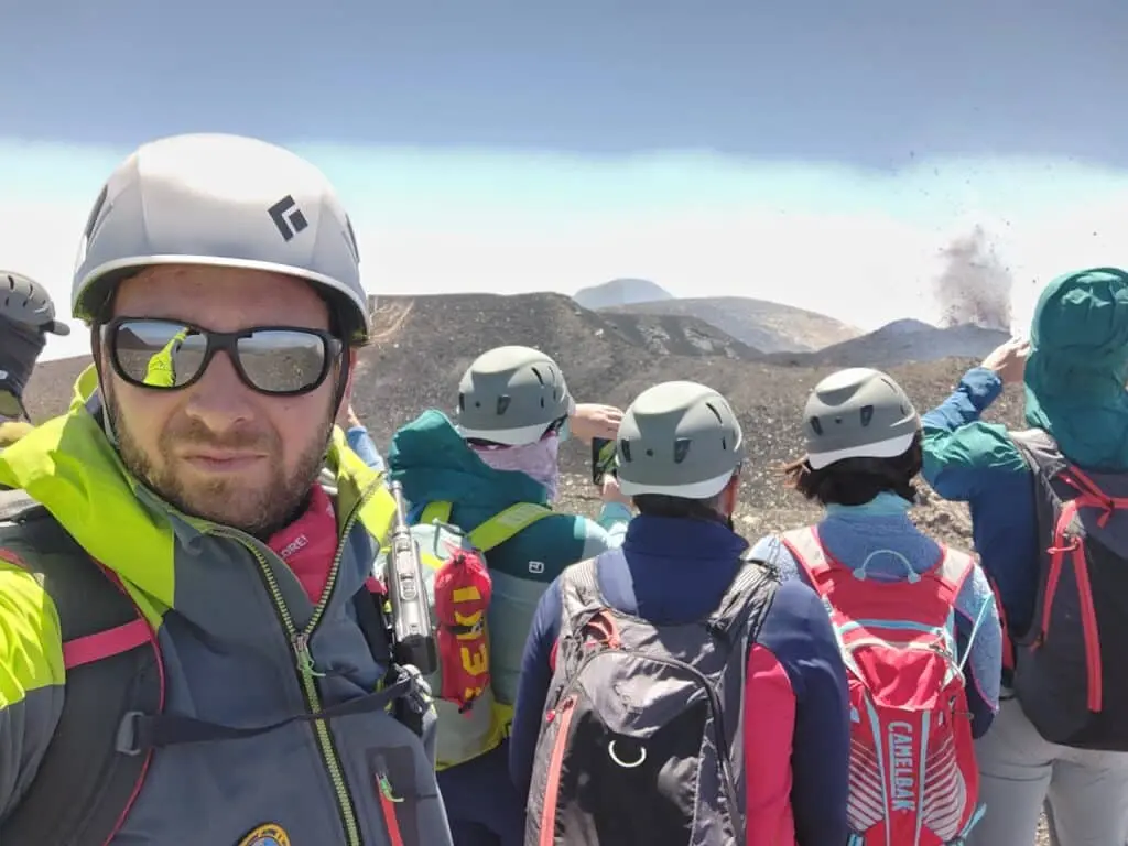 The final climb to summit Mount Etna — hikers near the top