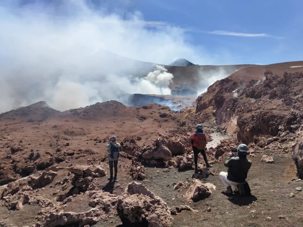 Trekking Mount Etna — hikers ascending the volcanic slopes